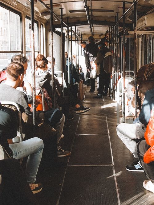 Free Passengers seated inside a tram in Belgrade, Serbia, on a sunny day showcasing urban life. Stock Photo