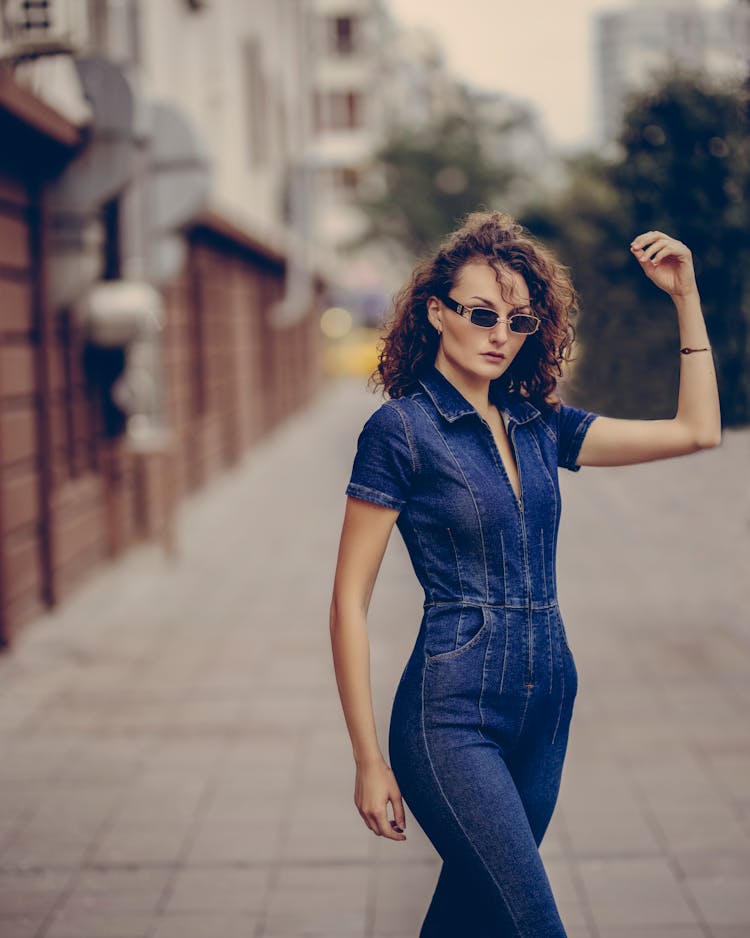 Woman In Jean Overalls On Sidewalk