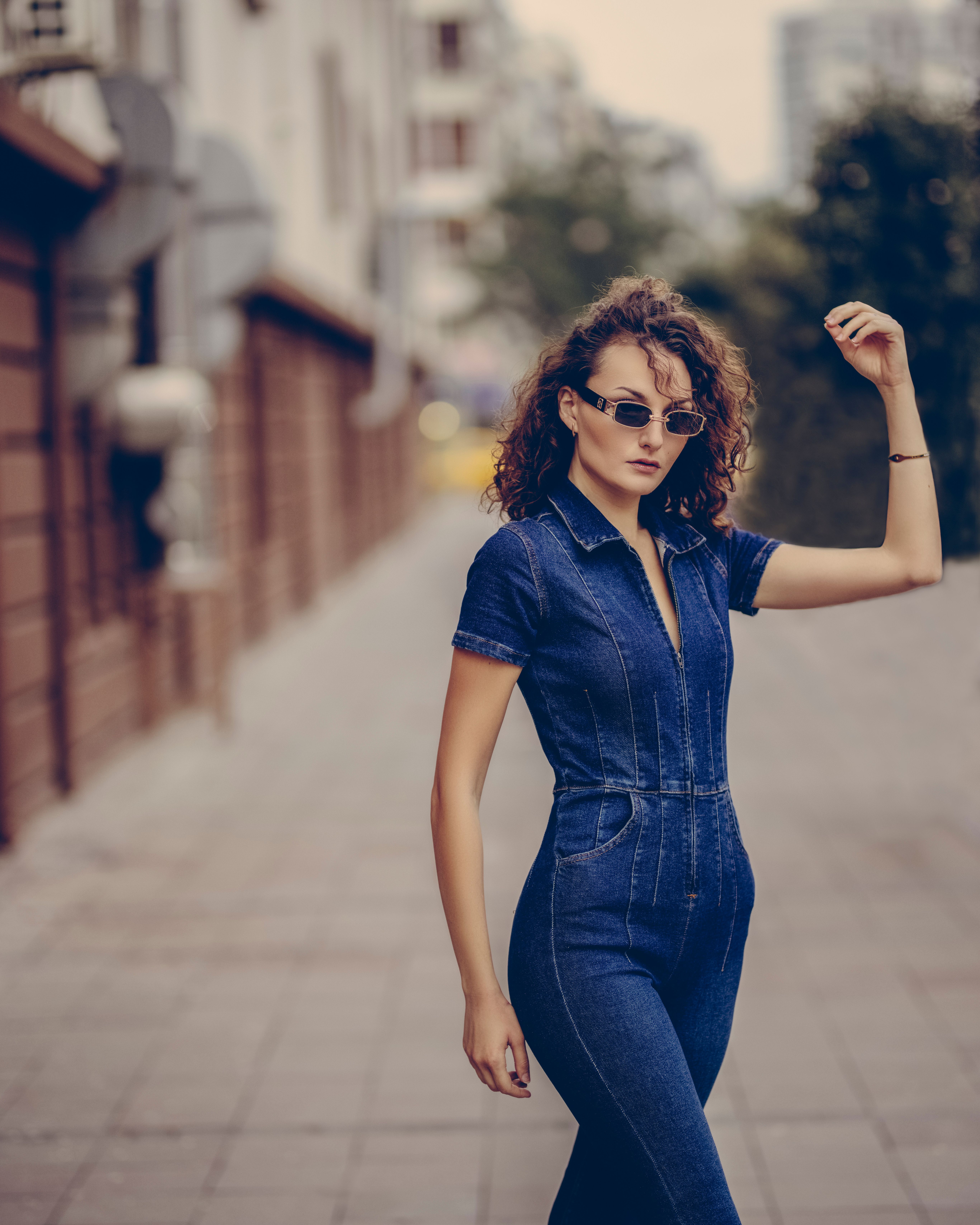 Woman in acid wash denim jumpsuit