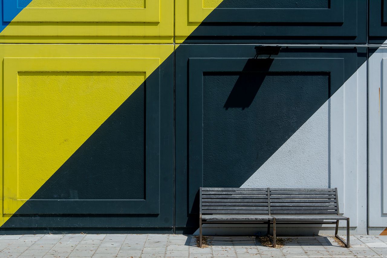modern urban scene with a colorful geometric wall and empty bench on a