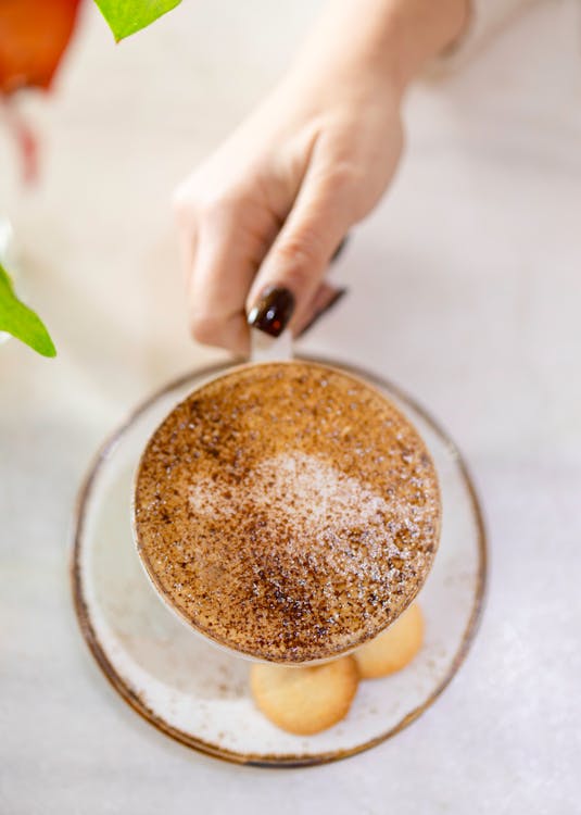 Hand Holding Mug of Beverage