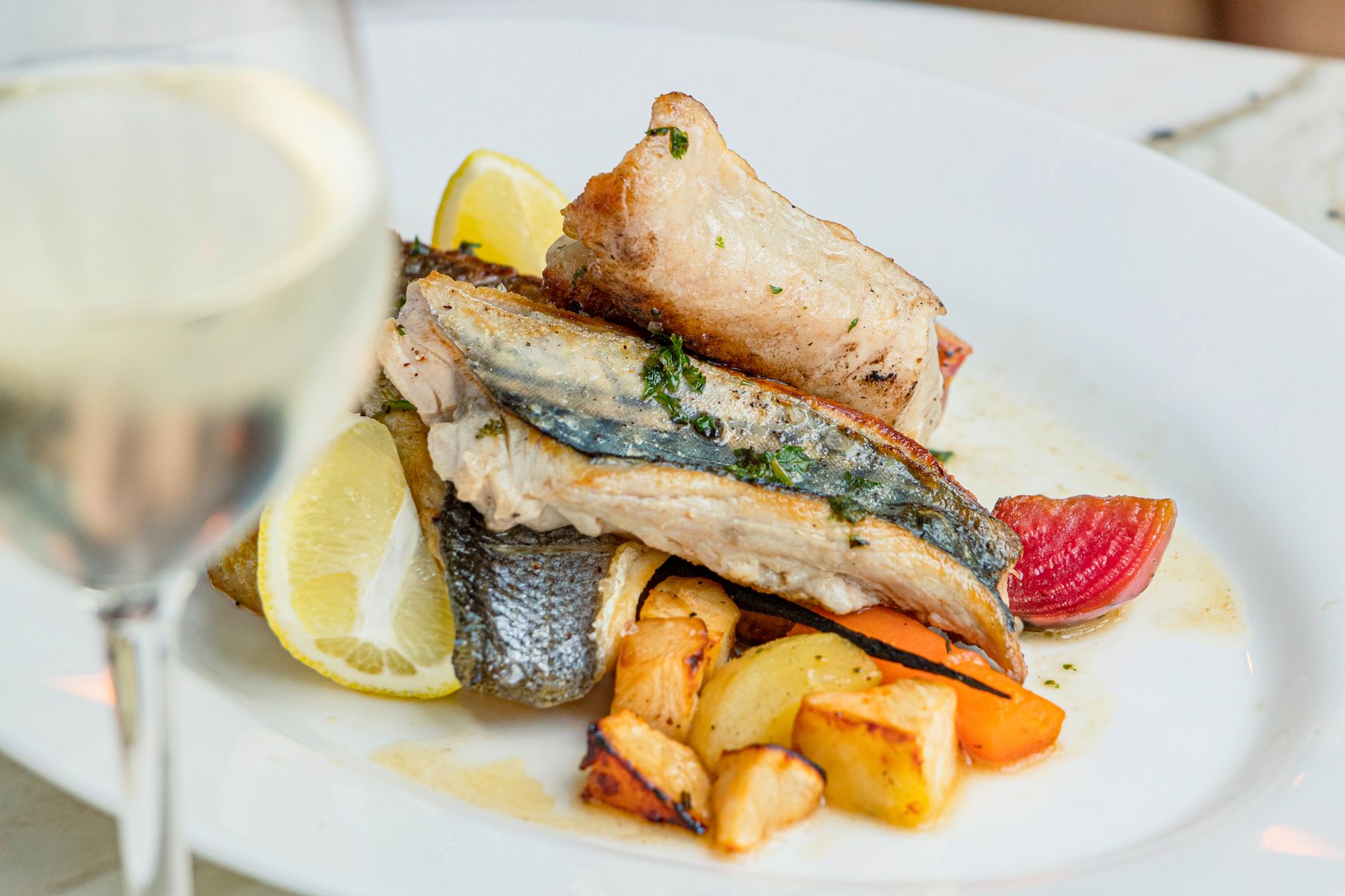 Baked mahi mahi with wine and herbs on plate