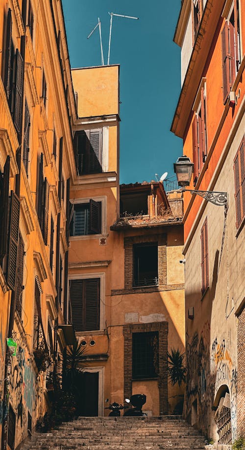 A narrow alley with buildings and a street sign