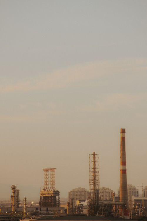Free A hazy skyline view of an industrial area in Baku, Azerbaijan with smokestacks and buildings. Stock Photo