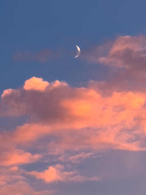 Purple Clouds and Crescent Moon on a Sunset Sky 