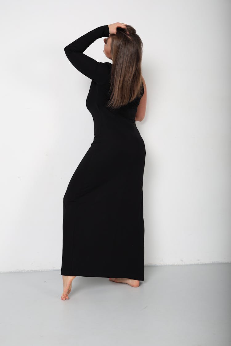 Woman Posing In Black Dress In A Studio 