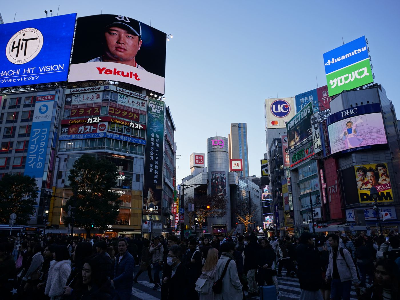 Shibuya Crossing in Tokyo, Japan, with crowds and neon signage