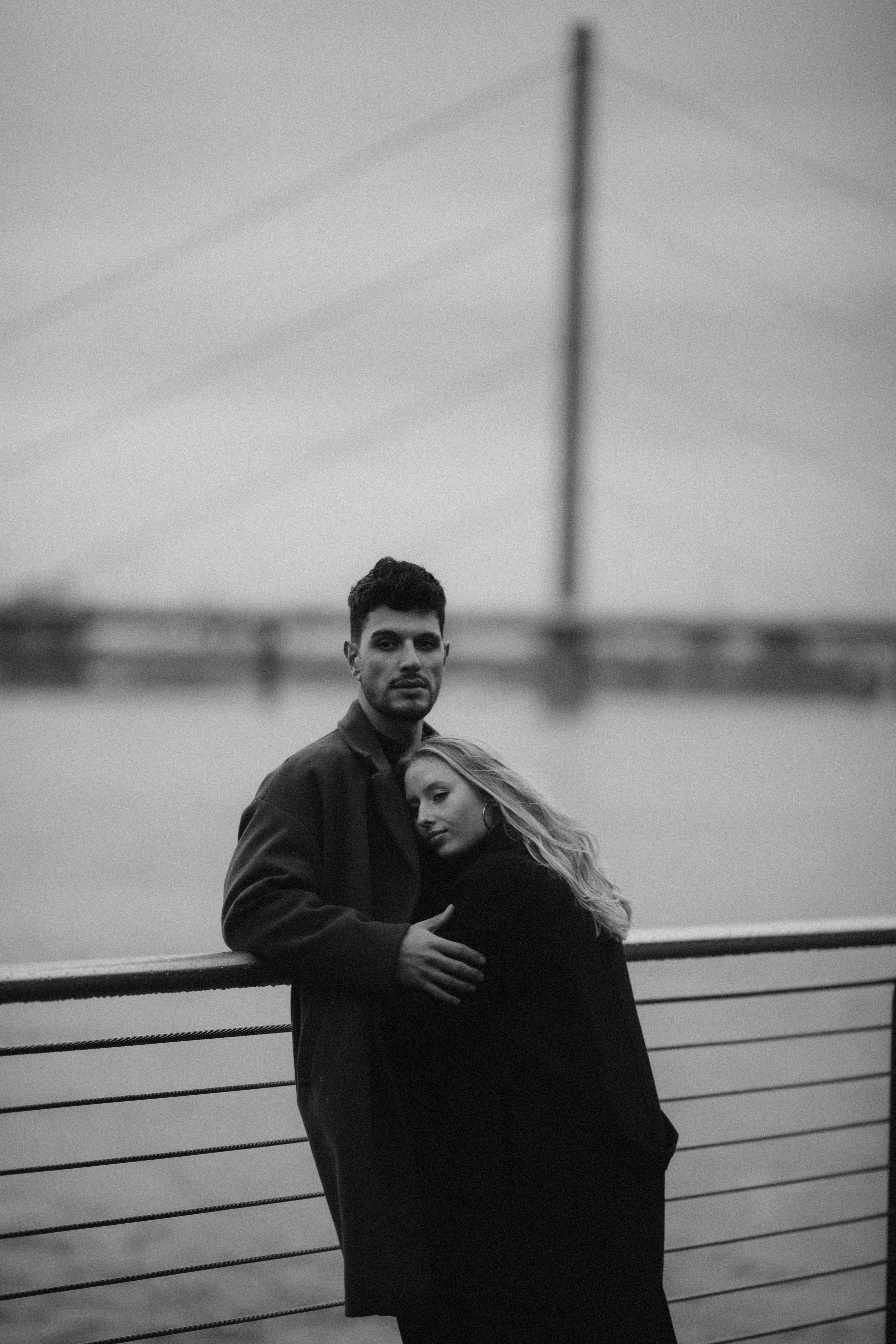 Couple embracing on a urban promenade in Düsseldorf, capturing romance.