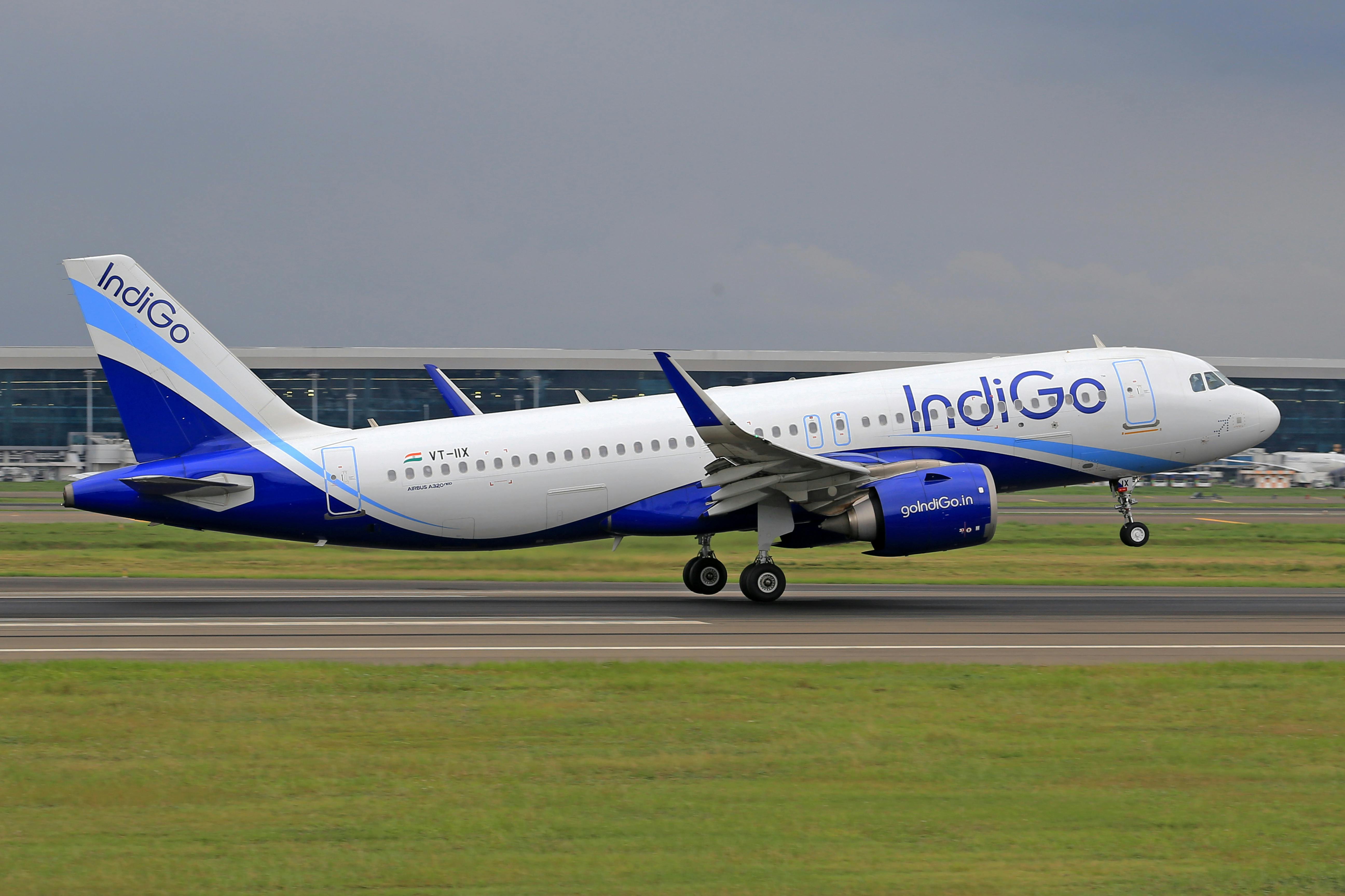 IndiGo plane at Manchester airport with passengers boarding