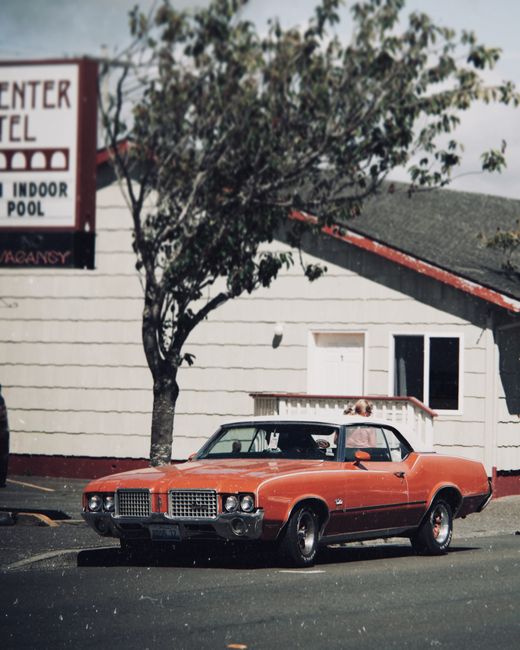 Classic vintage muscle car parked outside a retro motel in Portland, Oregon.
