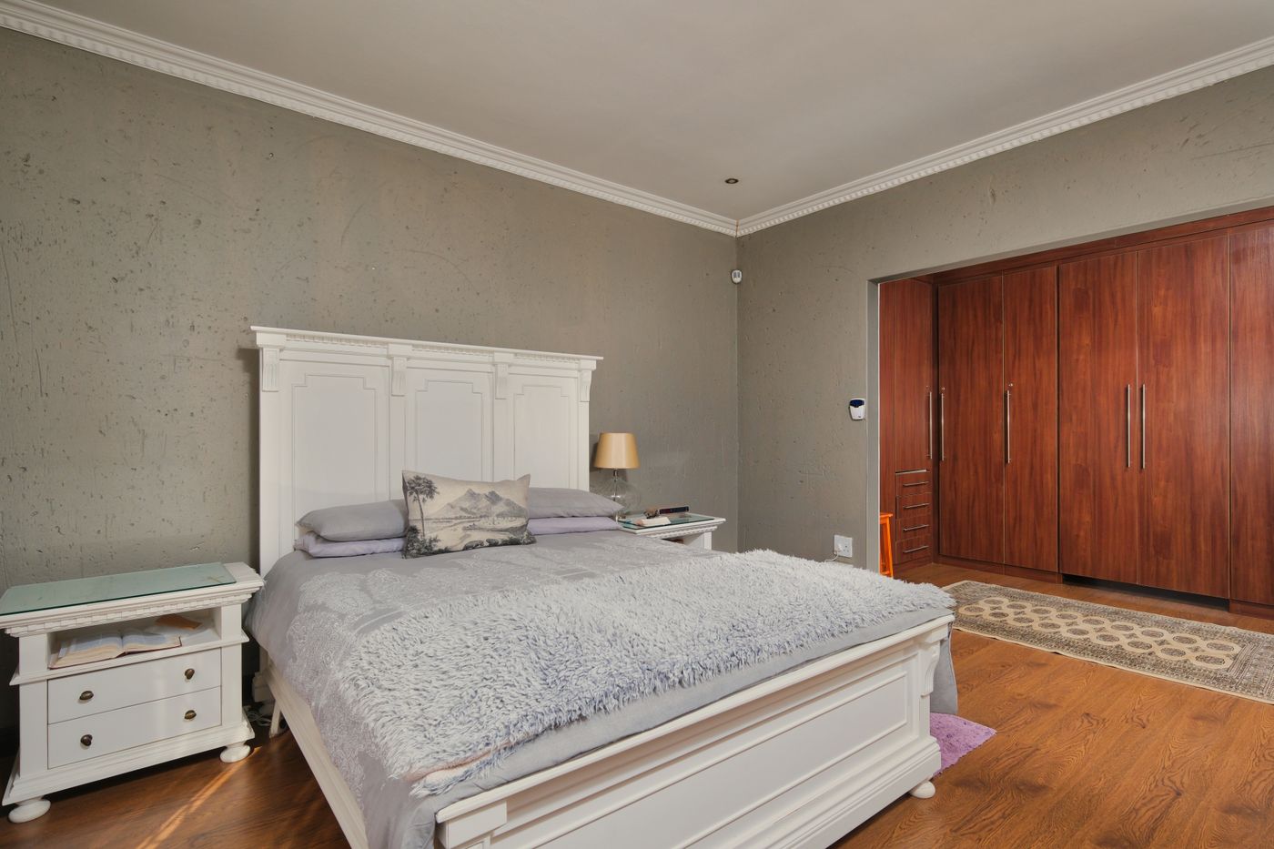 Modern bedroom interior with fitted wooden wardrobe