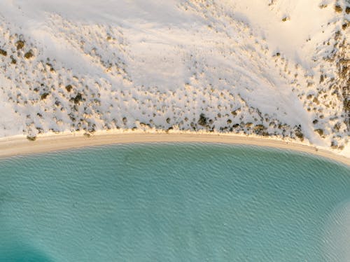 Aerial View of Sandy Coast and Turquoise Ocean