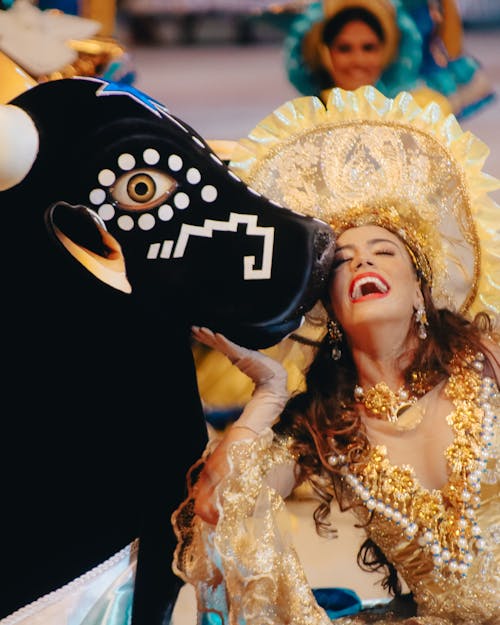 Laughing Woman in Golden Dress with Bull Mascot