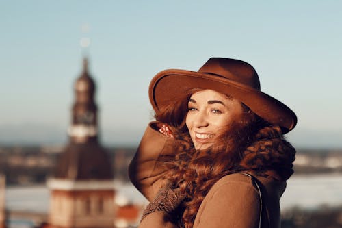 Smiling Model in a Brown Hat and Coat