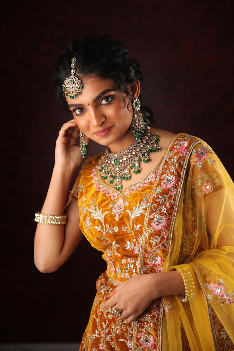 Brunette Woman In Orange Dress With Jewellery