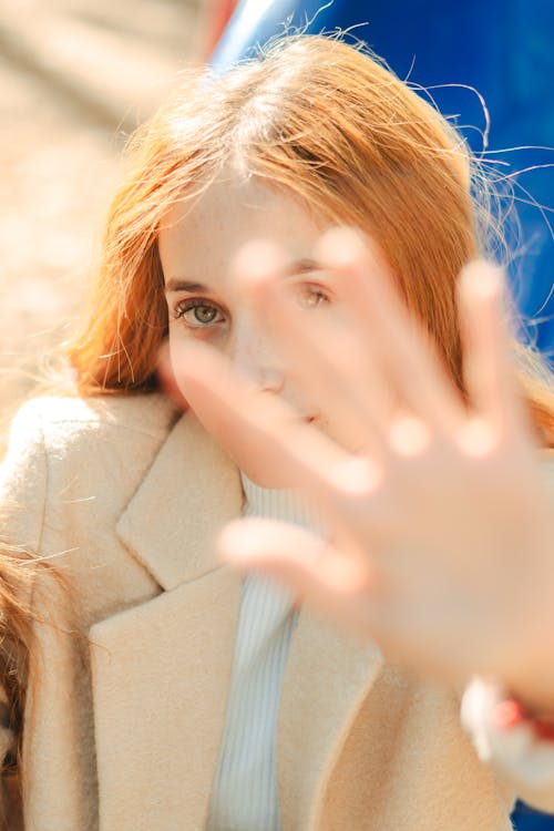 Young Woman Reaching Her Hand Toward the Camera 