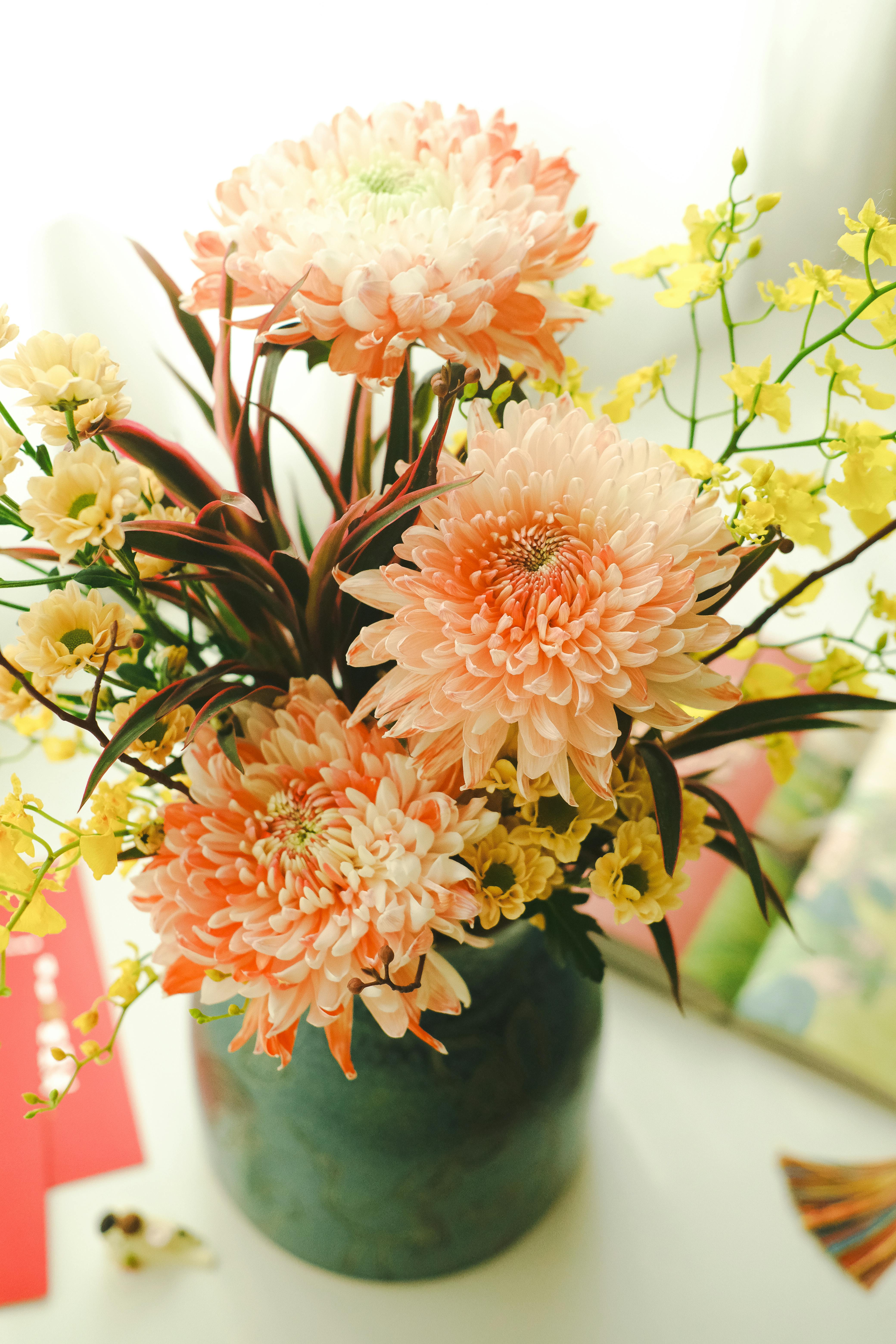Colorful bouquet of chrysanthemums in a vase, captured indoors with natural lighting.