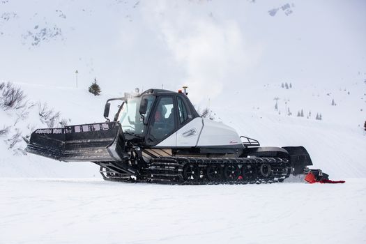 Snow groomer clearing snow on the slopes of Saint-Gervais-les-Bains.