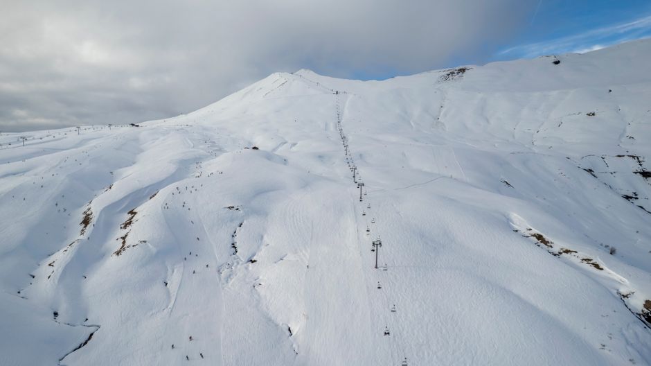 Aerial view of snow-covered ski slopes and lifts in Les Contamines-Montjoie, France.