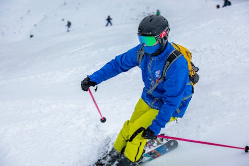 Closeup of a Skier Wearing a Blue Ski Jacket and Yellow Trousers
