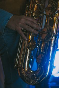Detailed shot of a saxophonist's hand playing the instrument. Captured in Roma, Italy.