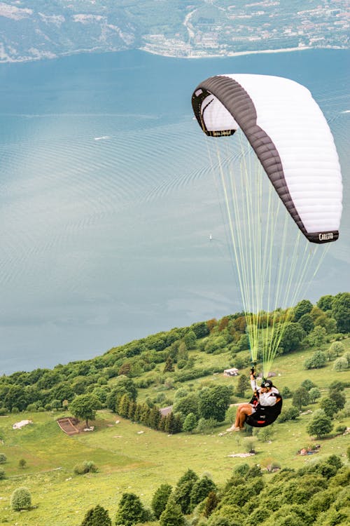 A Person Paragliding Near a Lake