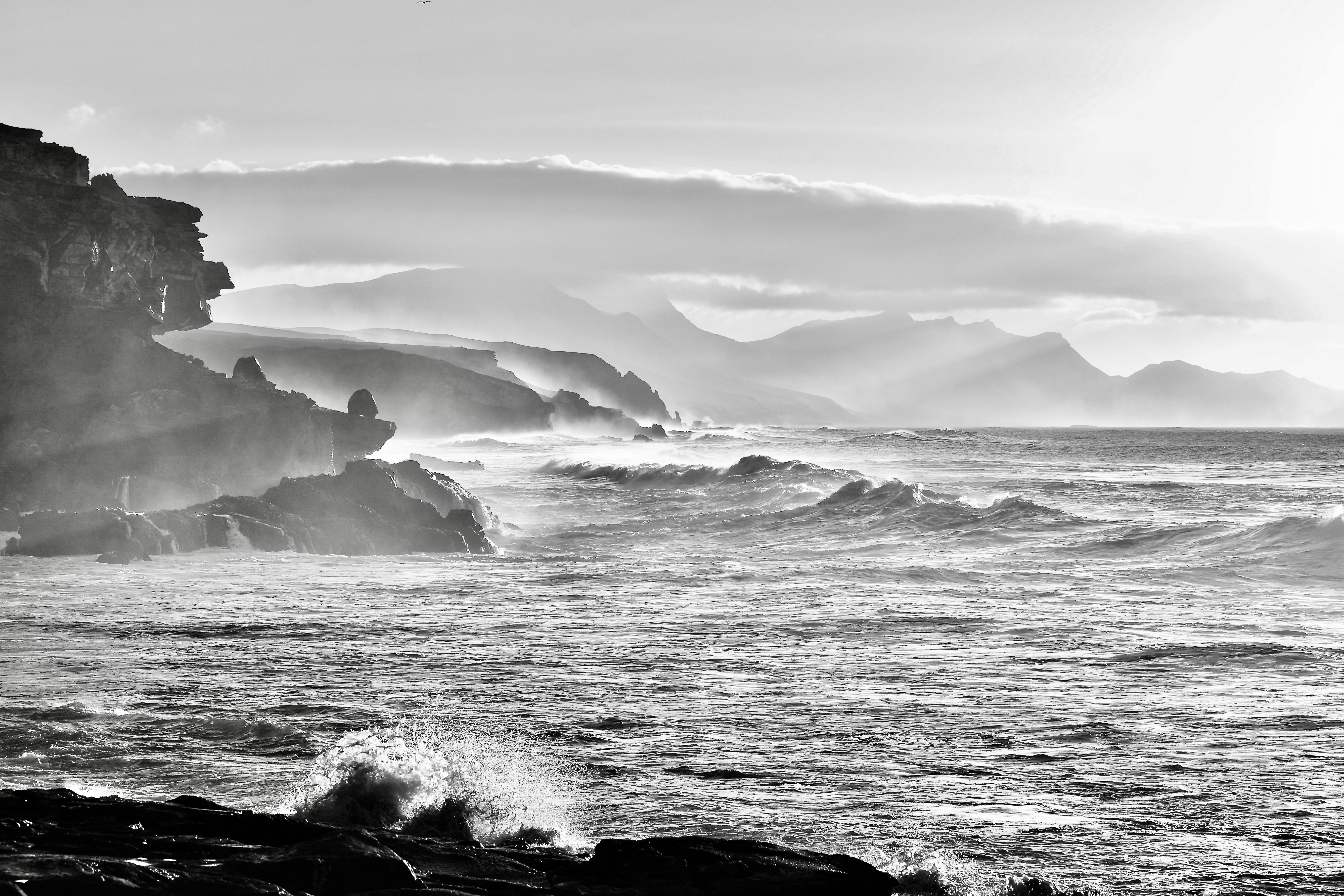 Black and White Photo of Waves Breaking on a Rocky Shore · Free Stock Photo