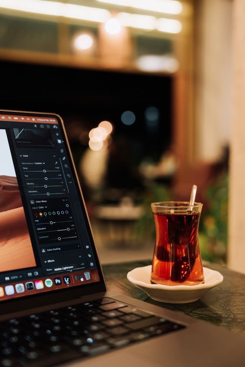 Computer With Tea Laptop and a Glass with Tea Standing on the Table · Free Stock Photo