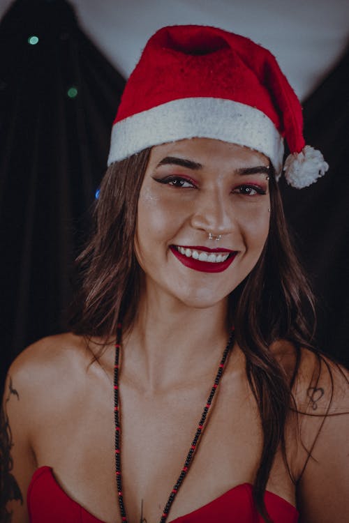 Young Woman Wearing a Santa Hat and Red Lipstick Smiling 