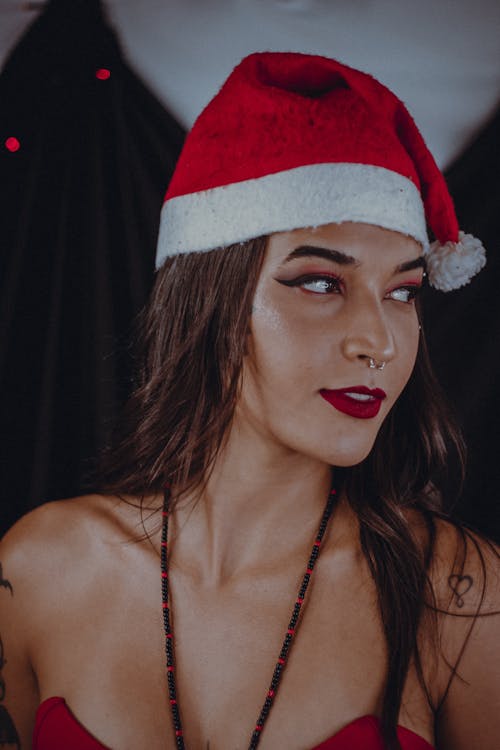 Young Woman Wearing a Santa Hat and Red Lipstick 
