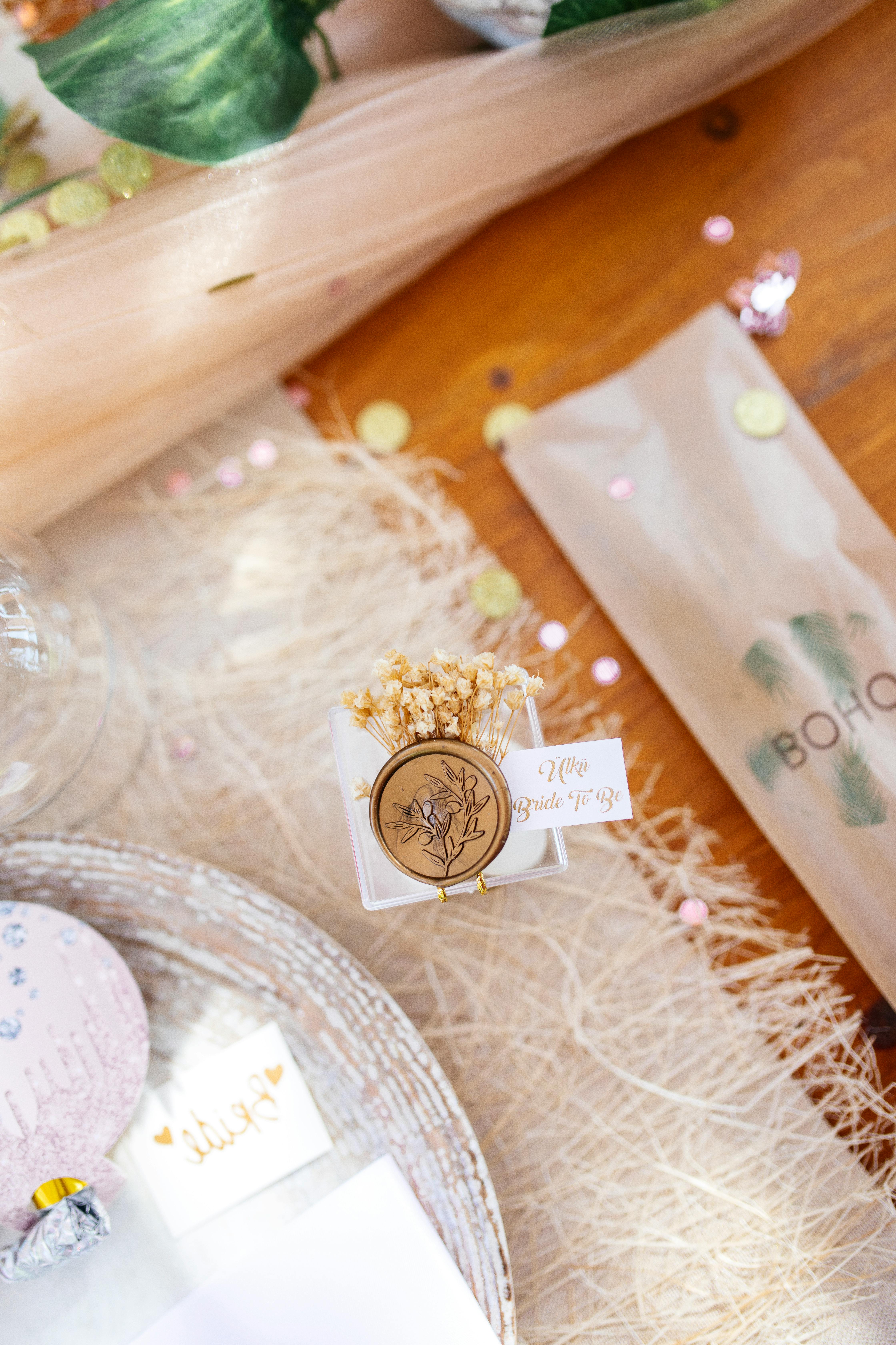 Stylish wedding table setup featuring delicate florals and a wax stamp for elegant decor.