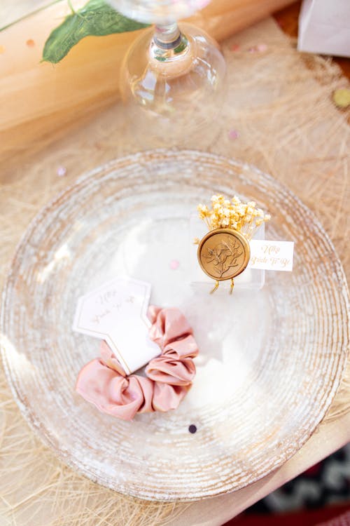 Pink Ribbon and Golden Coin on Glass Plate
