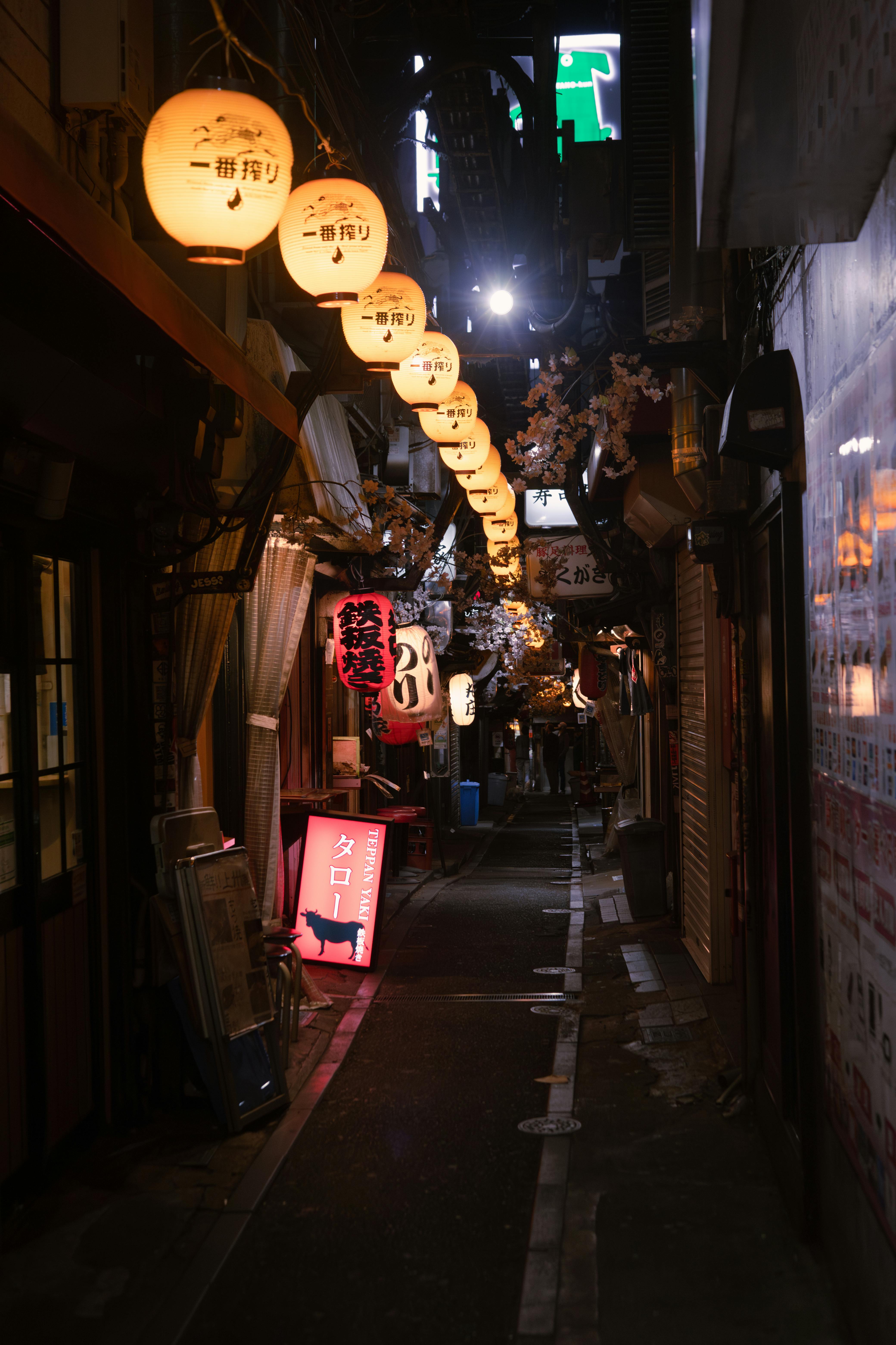 A Narrow Alley with Hanging Lantern in a Japanese City at Night