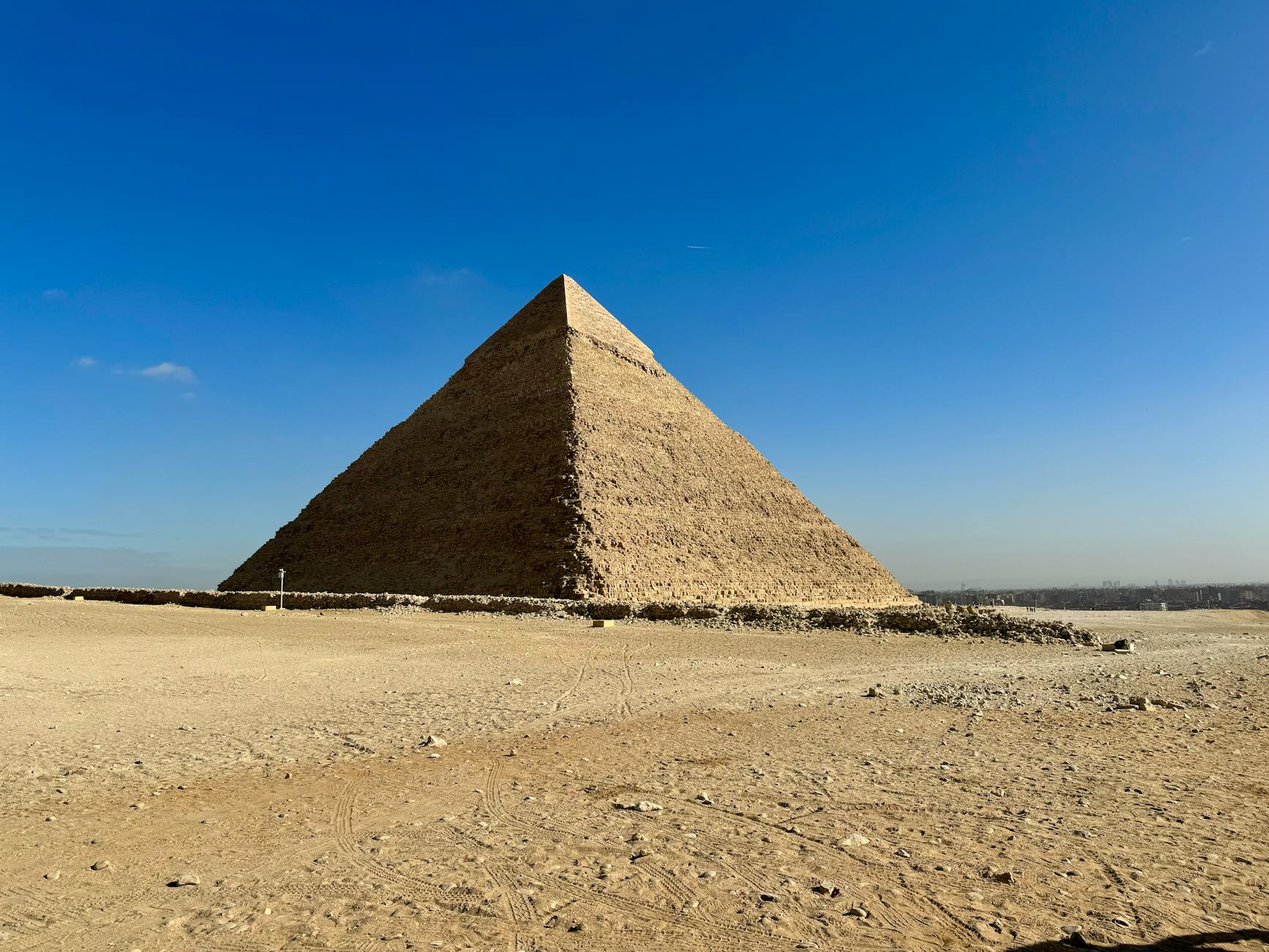 The Pyramid of Khafre stands majestically in Giza's desert, showcasing ancient Egyptian architecture.