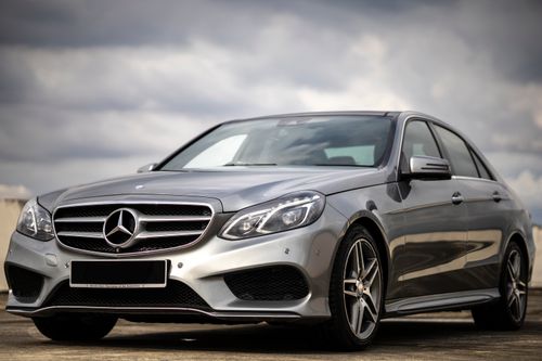Free Elegant silver Mercedes E300 parked outdoors in Johor Bahru, Malaysia, showcasing luxury and style. Stock Photo