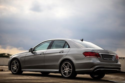 Free Sleek silver Mercedes E300 captured outdoors with a cloudy backdrop in Johor Bahru, Malaysia. Stock Photo