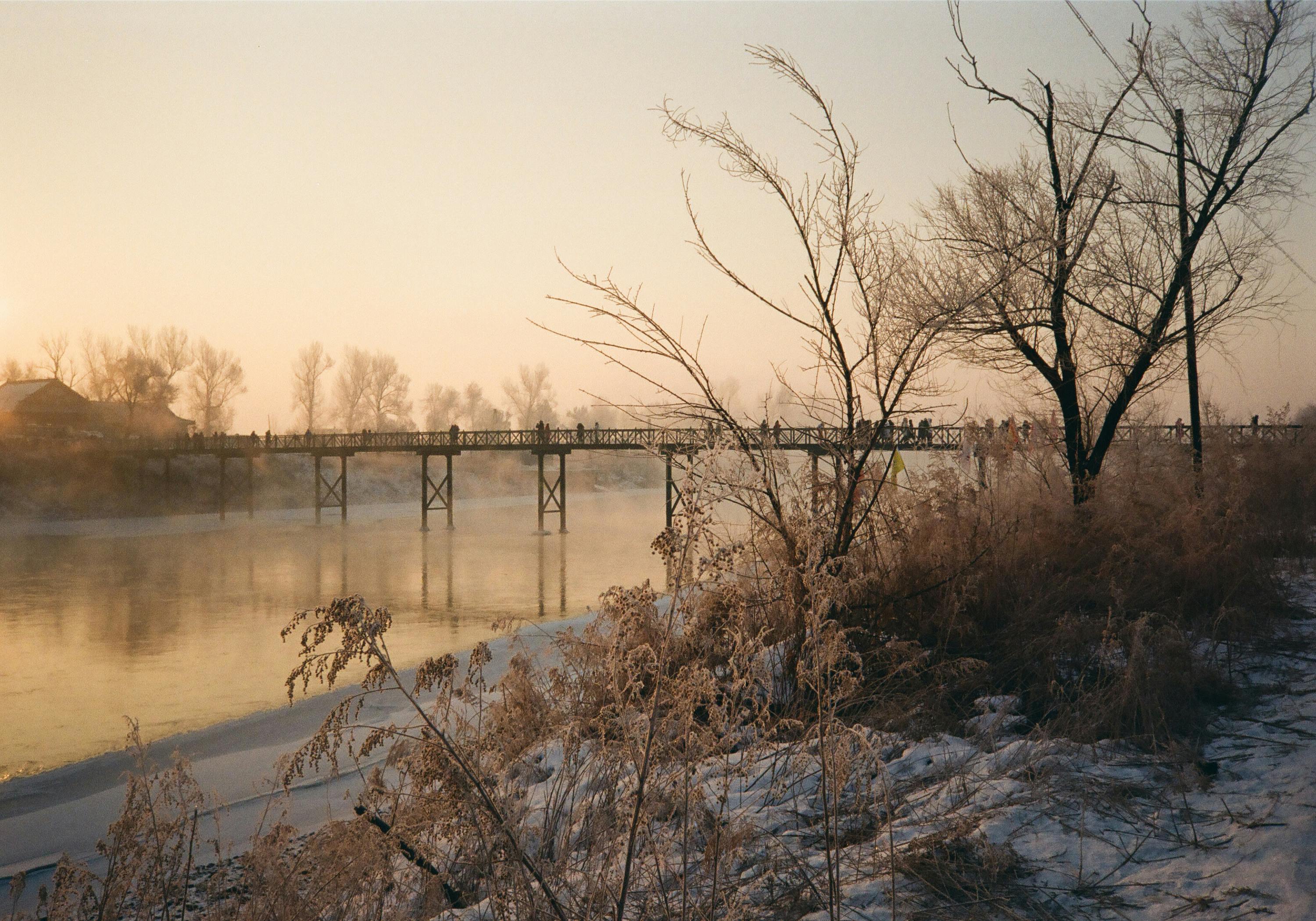 winter morning landscape with a bridge over a river