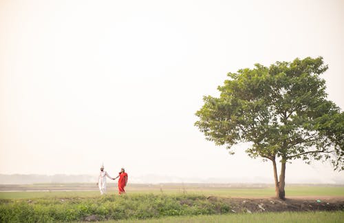 Couple in Traditional Costumes in Countryside