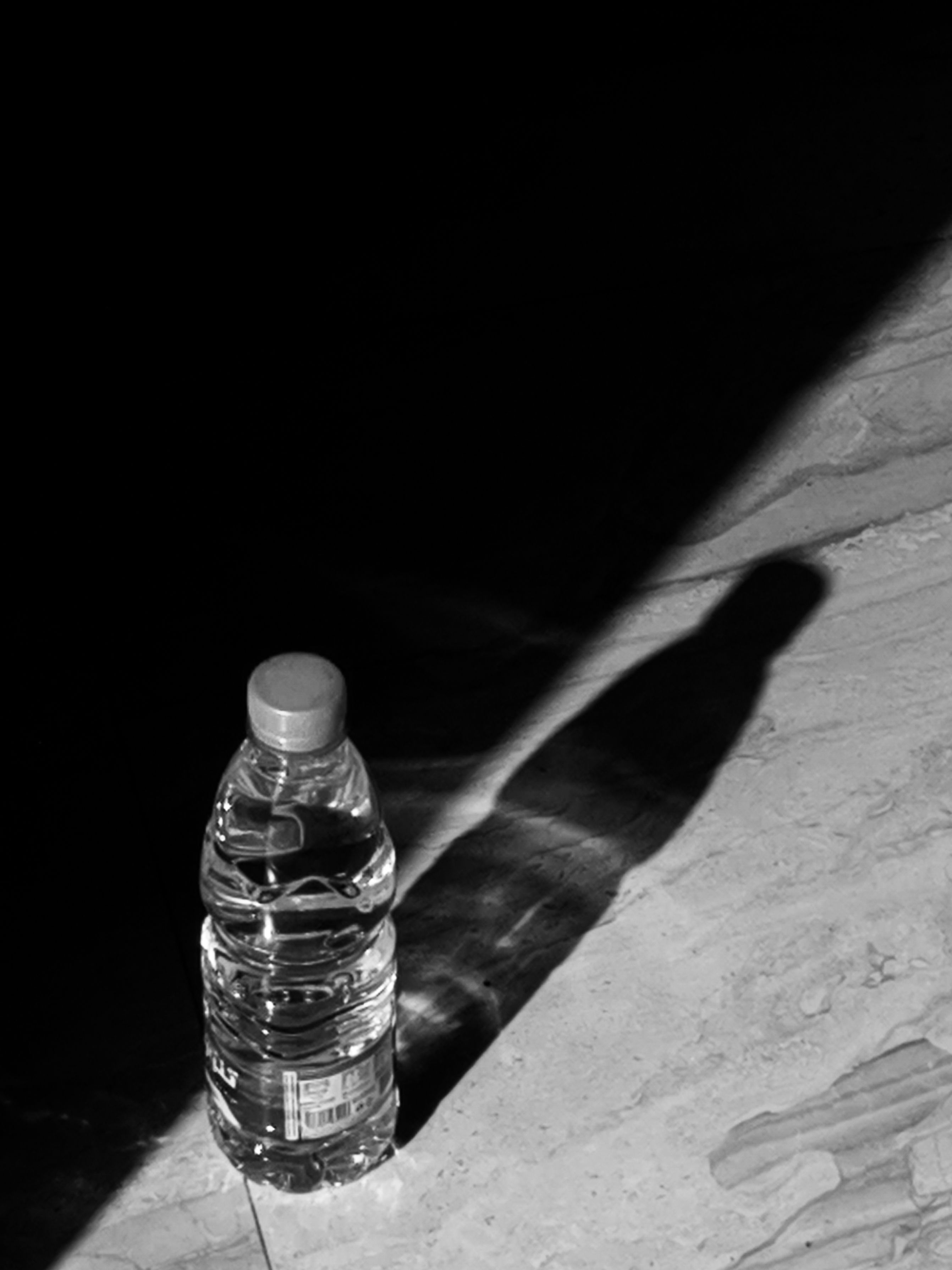 Bottle of Water Casting Shadow · Free Stock Photo
