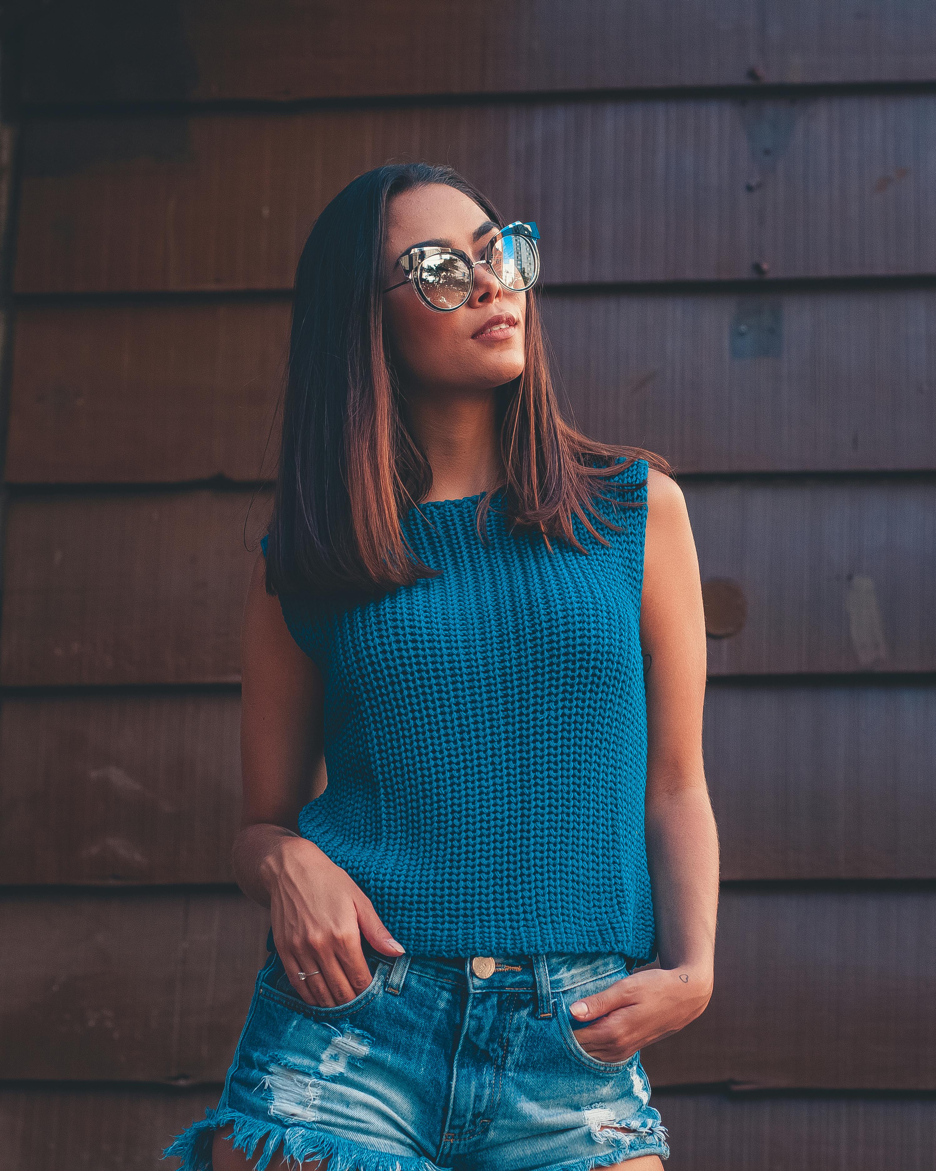 woman standing near brown wall