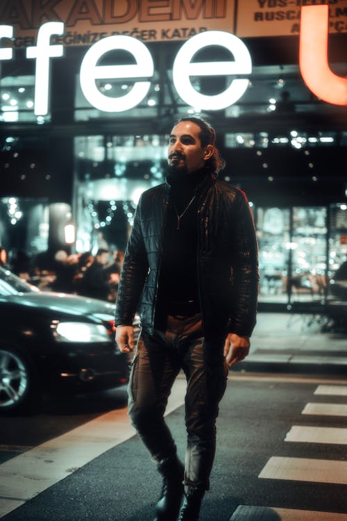 Man Crossing the Street in City on the Background of a Shopping Mall 