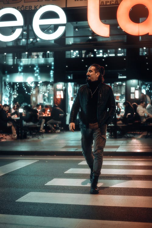 Man Crossing the Street in City at Night 