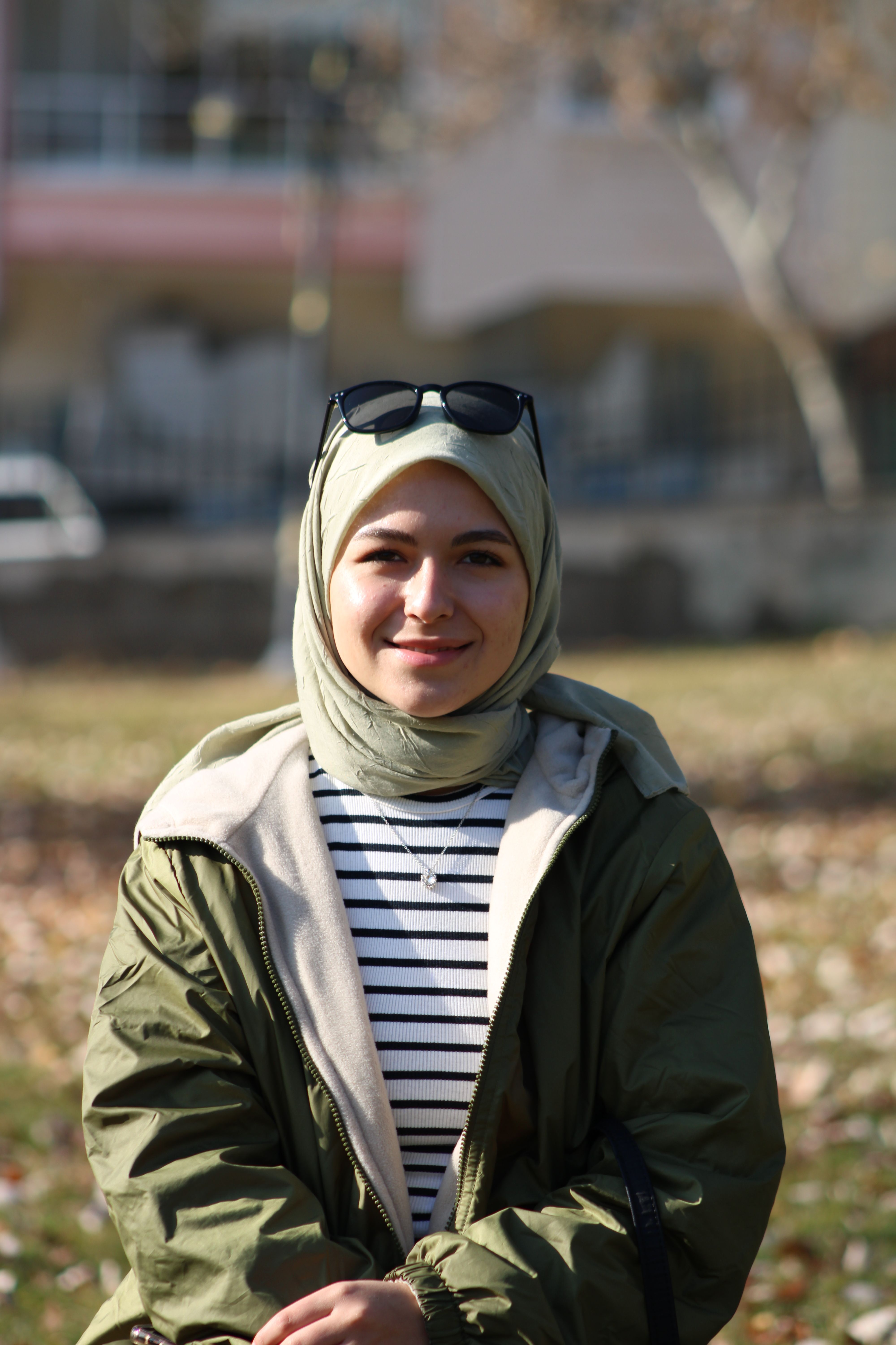 Woman with Sunglasses in Green Jacket Sitting · Free Stock Photo