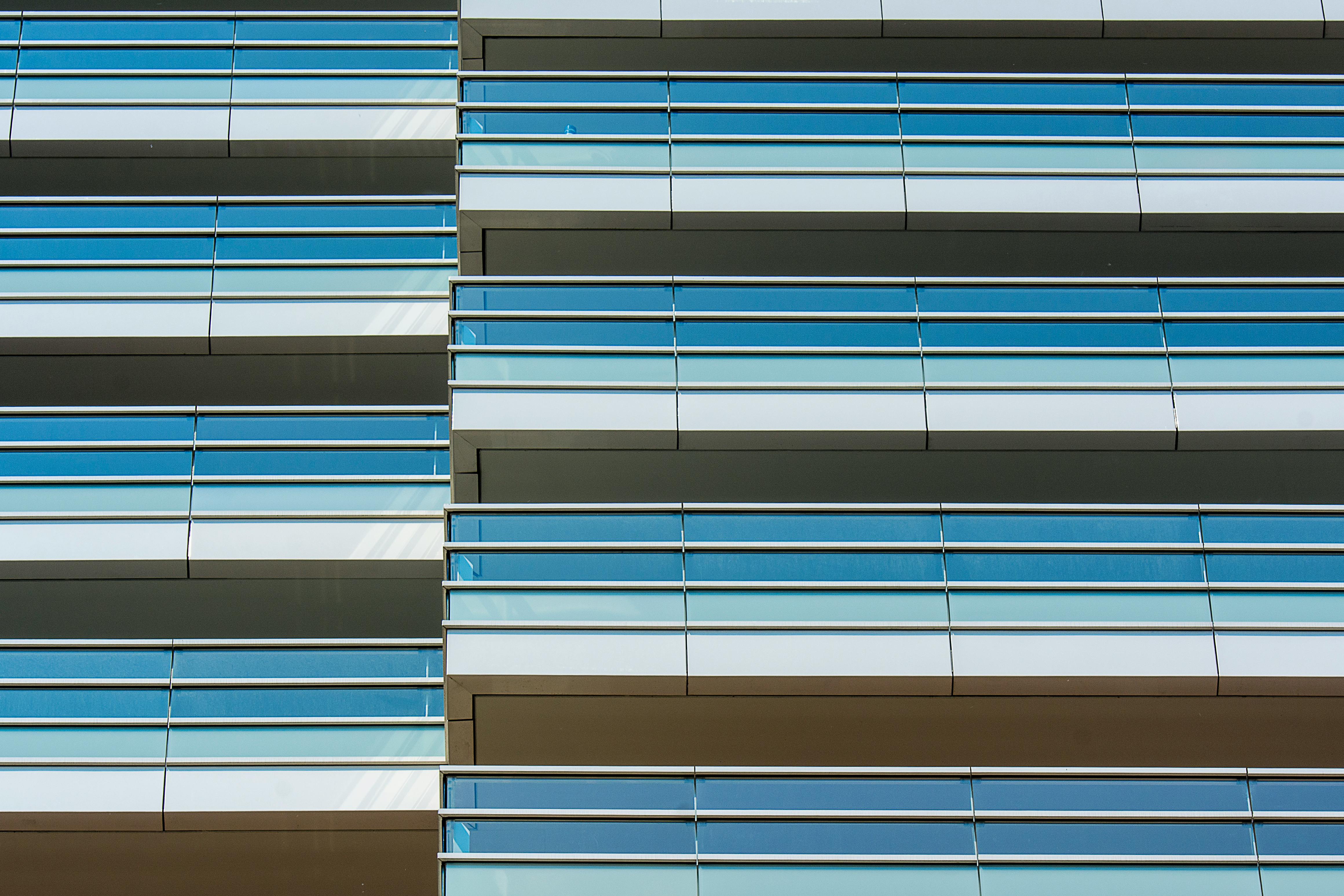 Close-up view of a modern glass facade with architectural lines and reflections.