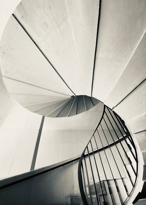 A black and white photo of a spiral staircase