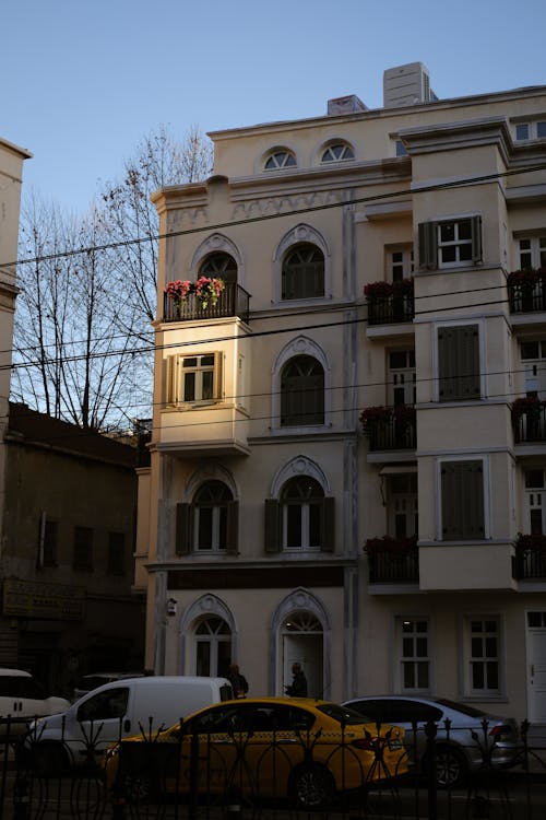 A building with a yellow car parked in front of it