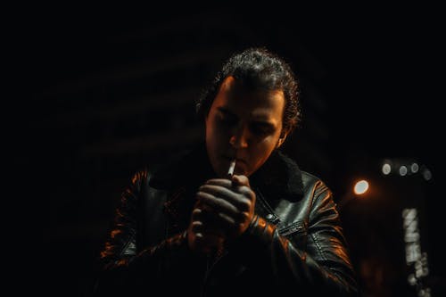 Man Lighting Cigarette at Night