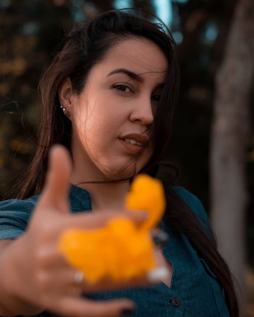 Woman Holding a Flower on a Stretched Out Hand