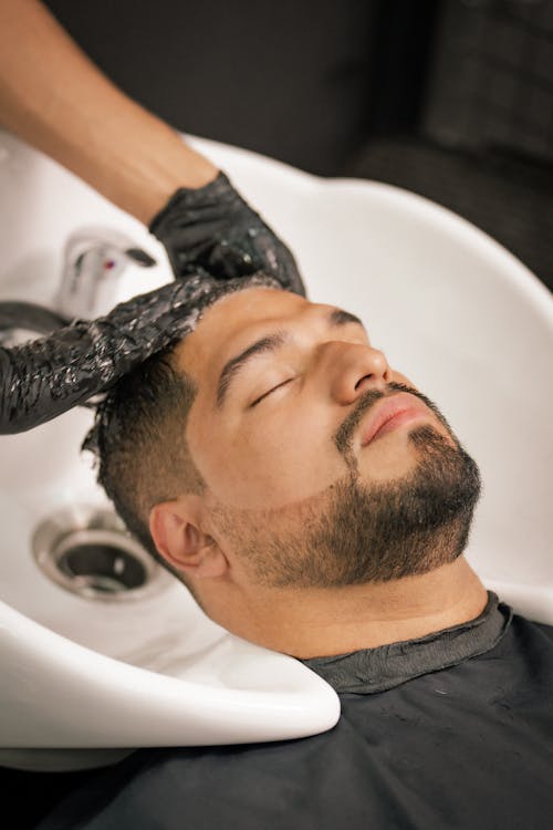 Man Getting His Hair Washed at a Barbershop 