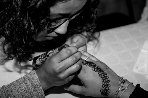 Woman Making Henna Tattoo on Hand